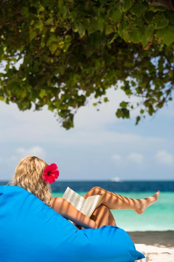 Malahini Kuda Bandos Resort Hulhumale Bagian luar foto A woman sunbathing on a beach