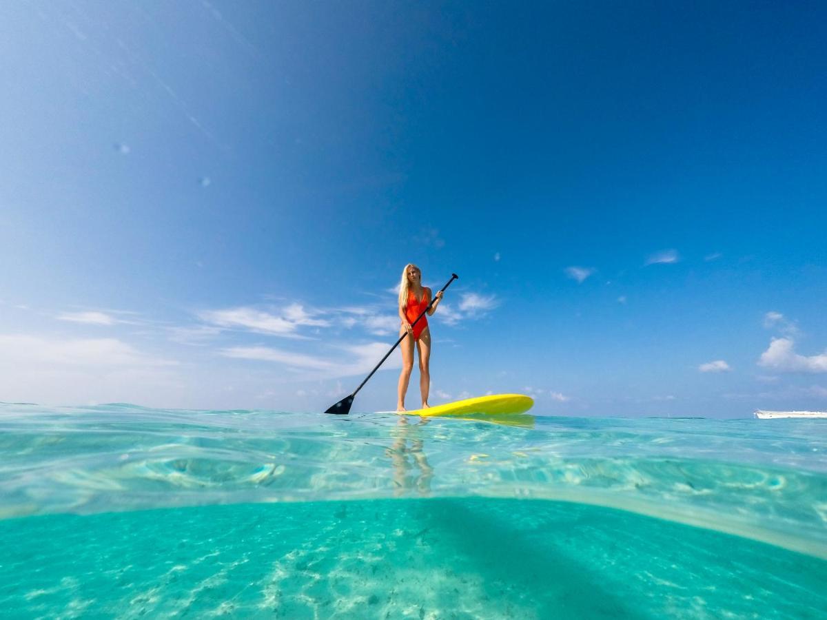 Malahini Kuda Bandos Resort Hulhumale Bagian luar foto Stand-up paddle boarder in the Maldives
